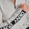 Jerséis de manga larga con cremallera de 1/4 y cinta con el logotipo Jerséis de manga larga con cremallera de 1/4 y cinta con el logotipo