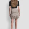 Mini falda con flecos y tachuelas