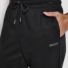 Pantalones Jogger con logo de pedrería y puños